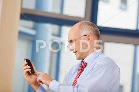 Businessman touching cell phone screen Stock Photos