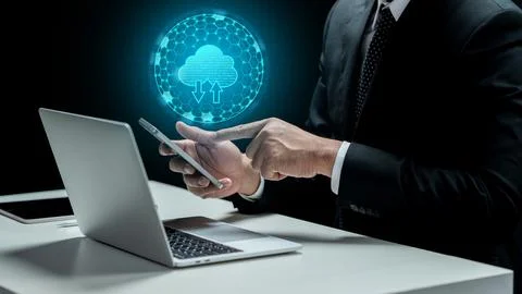 Businessman touching cellphone with cloud computing icon. Laptop and tablet.. 스톡 사진