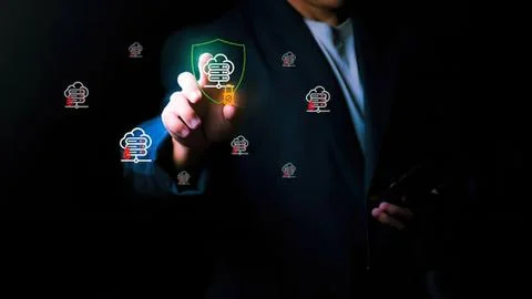 Businessman touching digital security shield icon on screen Stock Photos