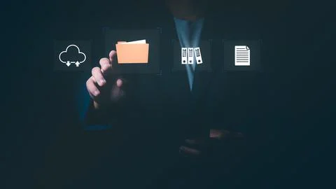 Businessman touching folder icon with cloud storage and document symbols, C.. Fotos de archivo