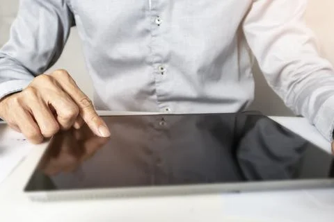 Businessman touching tablet screen checking work and conducting business ac.. Stock Photos