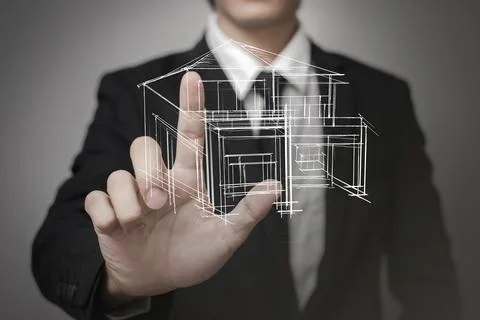 Businessman touching virtual screen a model of the house Stock Photos