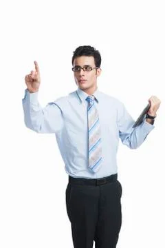 Businessman touching a visual screen and holding a digital tablet Stock-Fotos