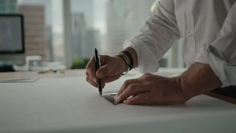 Businessman traces a project in office with view on downtown LA and skyscrapers Stock-Footage 127411978