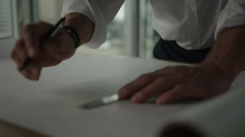Businessman traces a project in office with view on downtown LA and skyscrapers Video stock 127412178