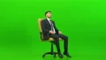 The businessman turning on the office chair on the green background 4k or 4k+ Resolution
