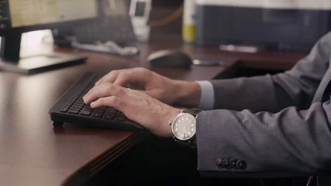 Businessman types on computer at work Stock Footage 94383247