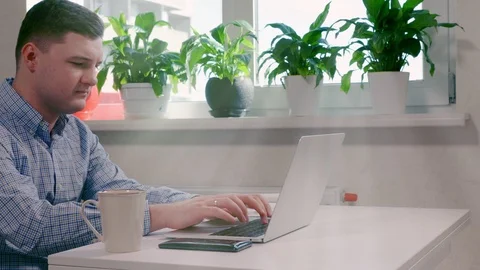 Businessman typing in data on a laptop Stock Footage 125897841