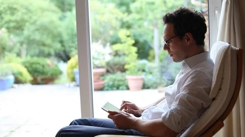 Businessman typing email message on tablet computer at home Stock Footage 98093691