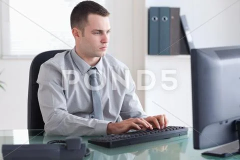 Businessman typing on his computer Stock Photos