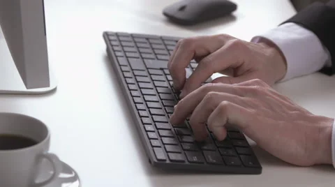 Businessman typing on a keyboard on a white table Stock Footage 62723958