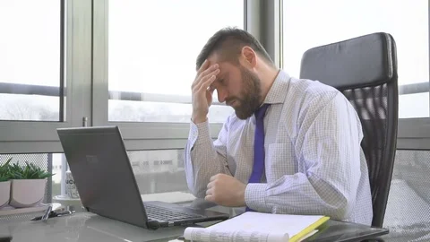 Businessman typing on laptop computer get a painful headache, in office Video stock 73169233