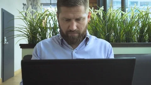 Businessman typing, on laptop, looking at camera, in cafe, portrait steadycam 動画素材 73299552
