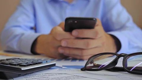 Businessman is typing a message on smartphone Video stock 128583522