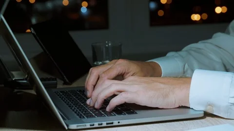 Businessman typing text or coding on laptop keyboard with hands in evening Stock Footage 95264964
