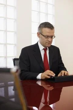 Businessman typing on touch pad computer Stock Photos