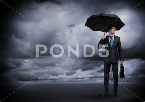 Businessman with umbrella Stock Photos