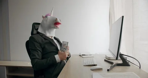 Businessman with unicorn mask counting stack cash money dollar profit salary Stock Footage 244131623