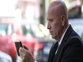 Businessman Use Touch Tablet Searching Email Crowded Street Traffic View 4k or 4k+ Resolution