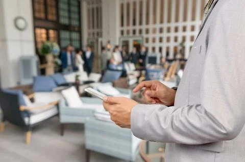 Businessman Use Wireless Tablet Device in Party at Restaurant with Bokeh Stock Photos