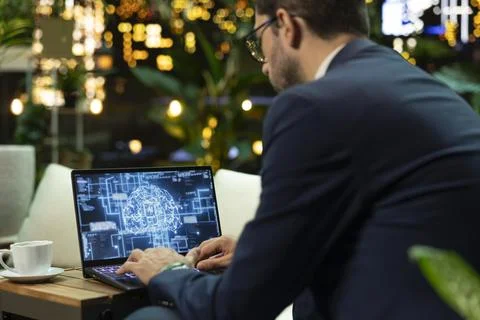 Businessman uses artificial intelligence interface on laptop Stock Photos