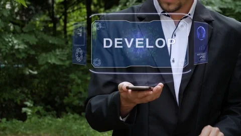 Businessman uses hologram with text Develop Vídeo Stock 116563296