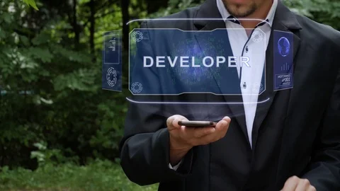 Businessman uses hologram with text Developer Stock Footage 116431190
