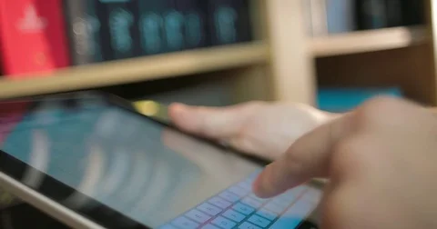 Businessman uses a tablet computer standing next to a large shelf Stock Footage 82969924