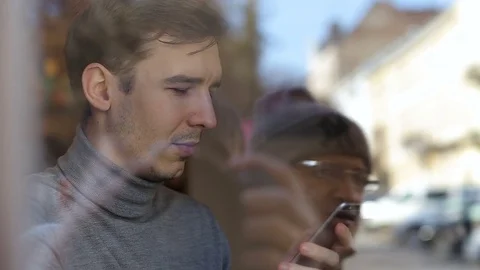 Businessman using app on smartphone and drinking coffee in cafe. Stock Footage 73020982