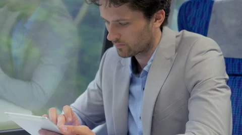 Businessman using an app while traveling on the train Stock Footage 67261442