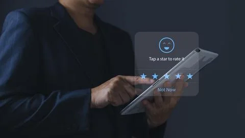A businessman using application on tablet the virtual screen to give satisf.. Stock Photos