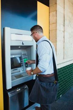 Businessman Using ATM Machine Stockfoto's