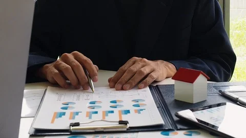 Businessman using ball pen point on graph paper. Stock Footage 117330152