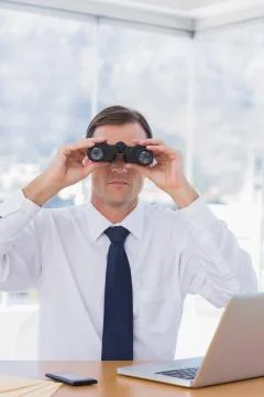 Businessman using binoculars in front of the camera 스톡 사진