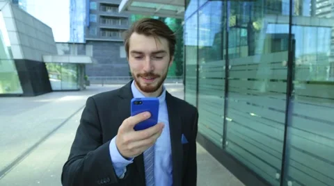 Businessman is using business app on smart phone walking in city Stock-Footage 67235592