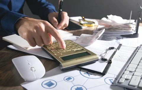 Businessman using calculator and checking bills. Business 스톡 사진
