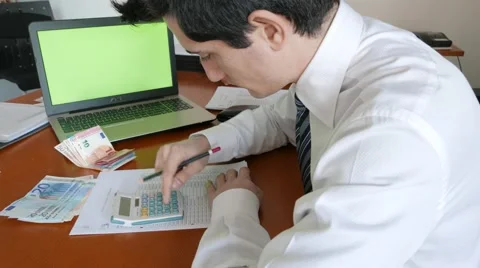 Businessman using calculator to control cash payments Stock Footage 61962357
