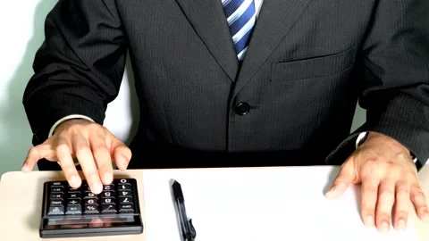 A businessman using a calculator Video stock 334806266