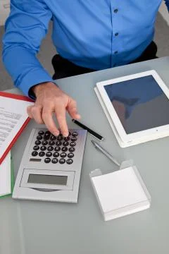 Businessman using a calculator Stock Photos