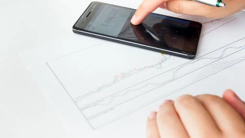 Businessman using calculator while analyzing financial stock market Foto stock