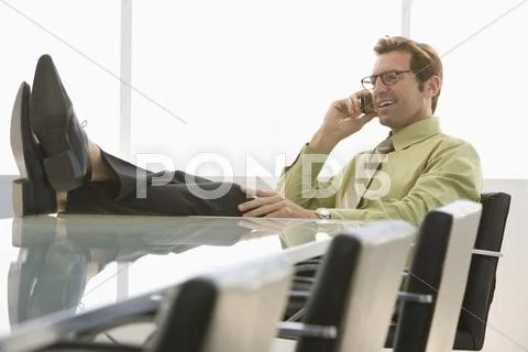 Businessman Using Cell Phone In Conference Room Stock Photos