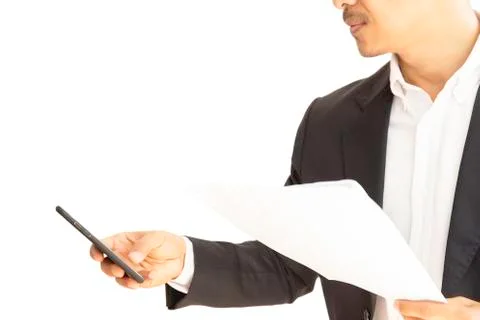 Businessman using cellphone working with documents isolated clipping path. Stock Photos