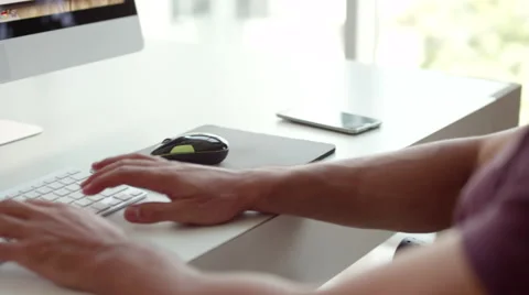 Businessman using computer and messaging on mobile at office. Stock Footage 64101266