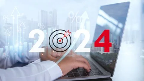 Businessman is using a computer and showing the letters 2024 representing s.. Stock Photos