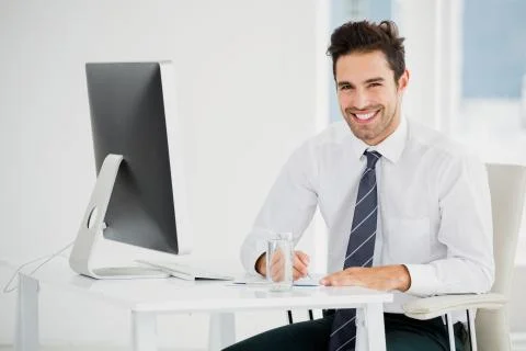 Businessman using computer and taking notes 스톡 사진