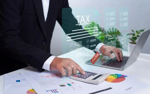 Businessman using a computer to complete Individual income tax return form .. Stock Photos