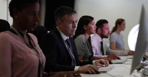 Businessman using computer in crowded office Video stock 79132345