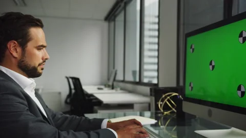 Businessman using a computer with green screen and typing on the keyboard Stock Footage 264245347