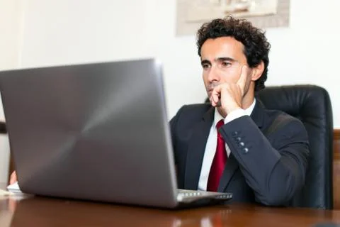 Businessman using a computer in his office Stock Photos