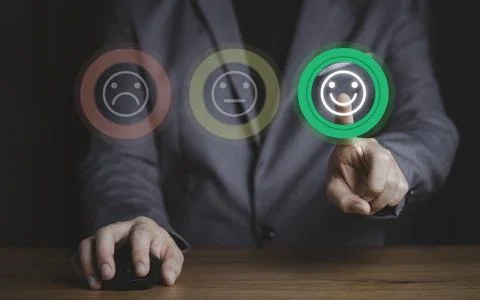 Businessman using computer mouse and pushing smile button Stock Photos